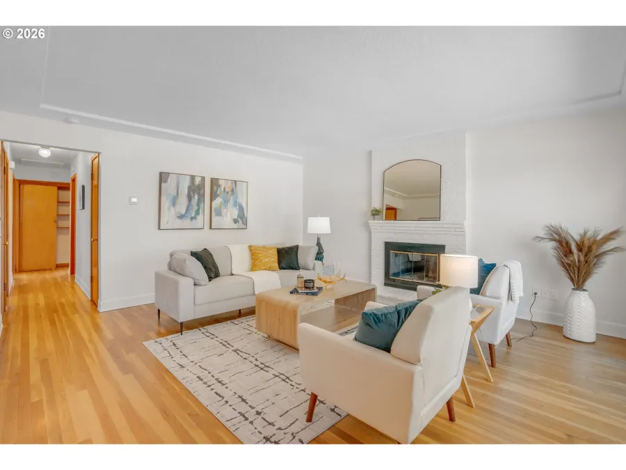 Bright living room staged by Willow & Fern with cream sofas, a patterned rug and a fireplace