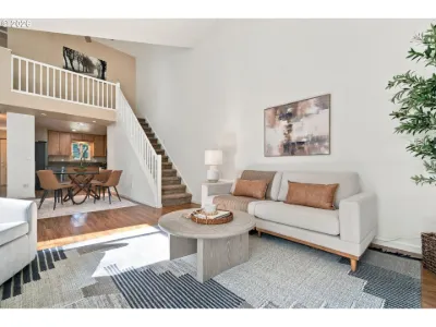 Staged living room and stairs in a home staged by Willow & Fern