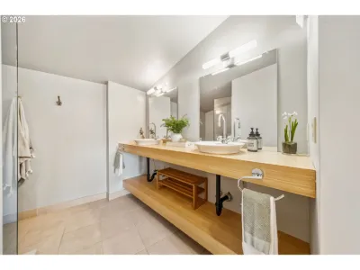 Bathroom with a wood vanity, white vessel sink and styled towels